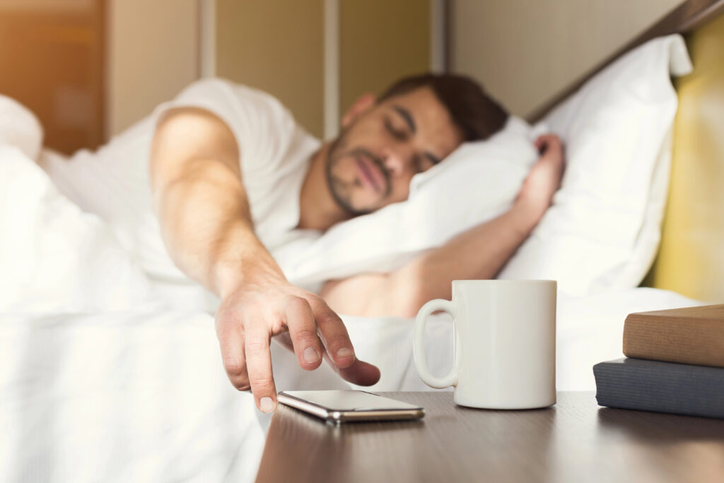 man snoozing alarm