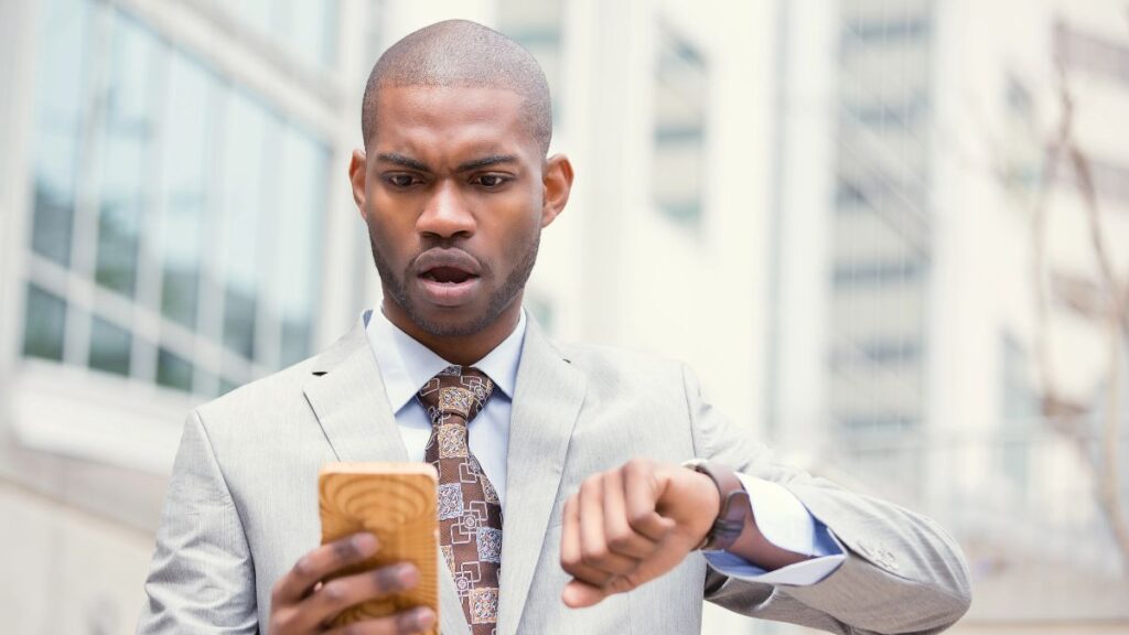 man with phone running late