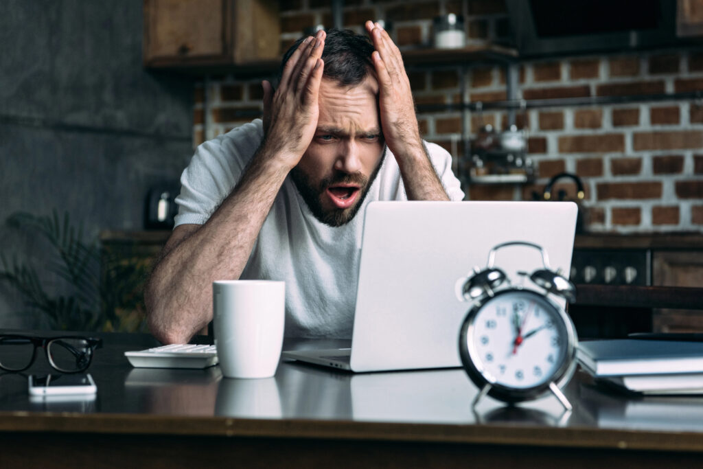 stressed man working on computer