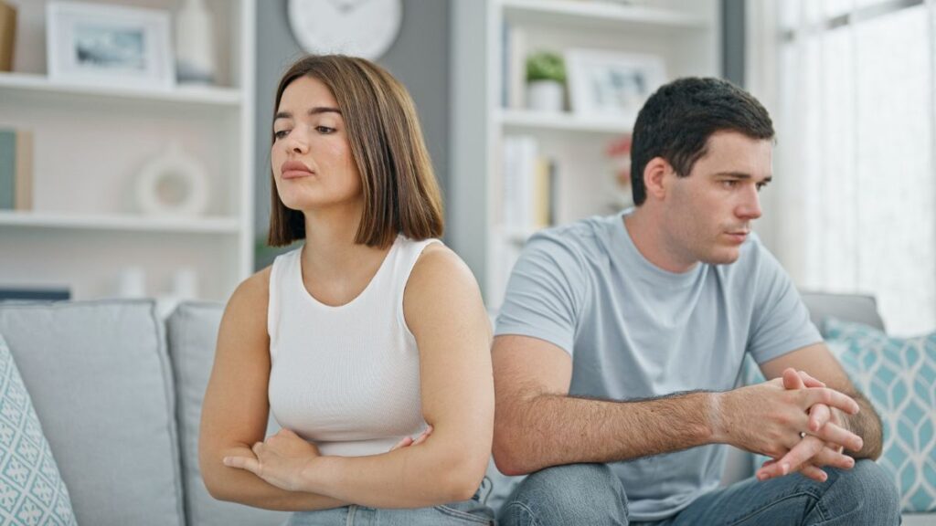 stubborn couple looking away on couch