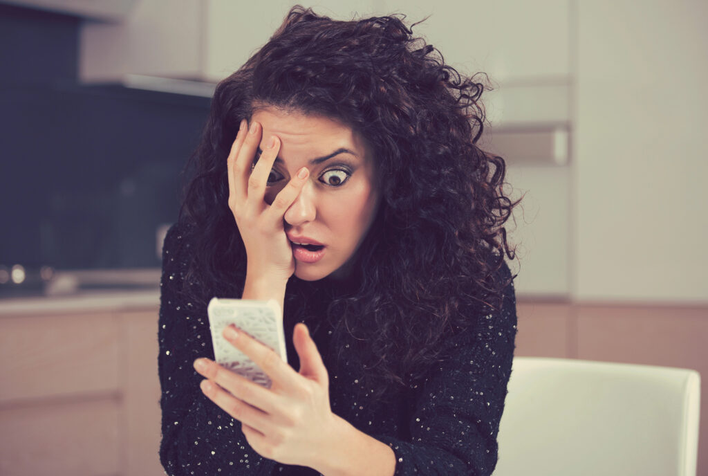 surprised woman looking at phone