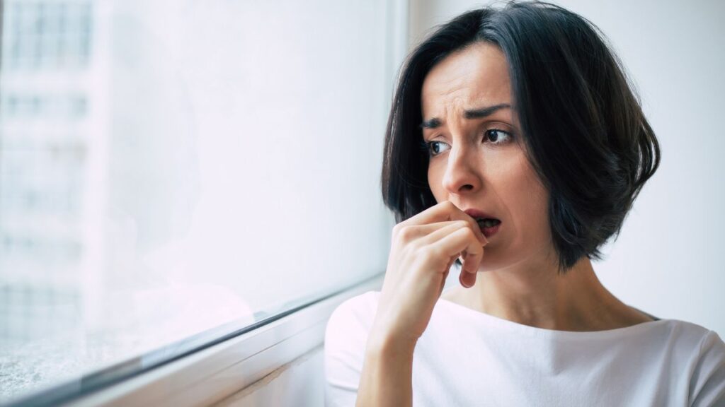 upset woman looking out window