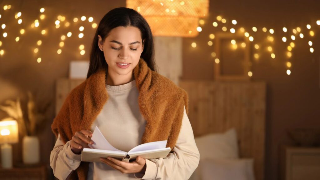 woman reading with brown sweater