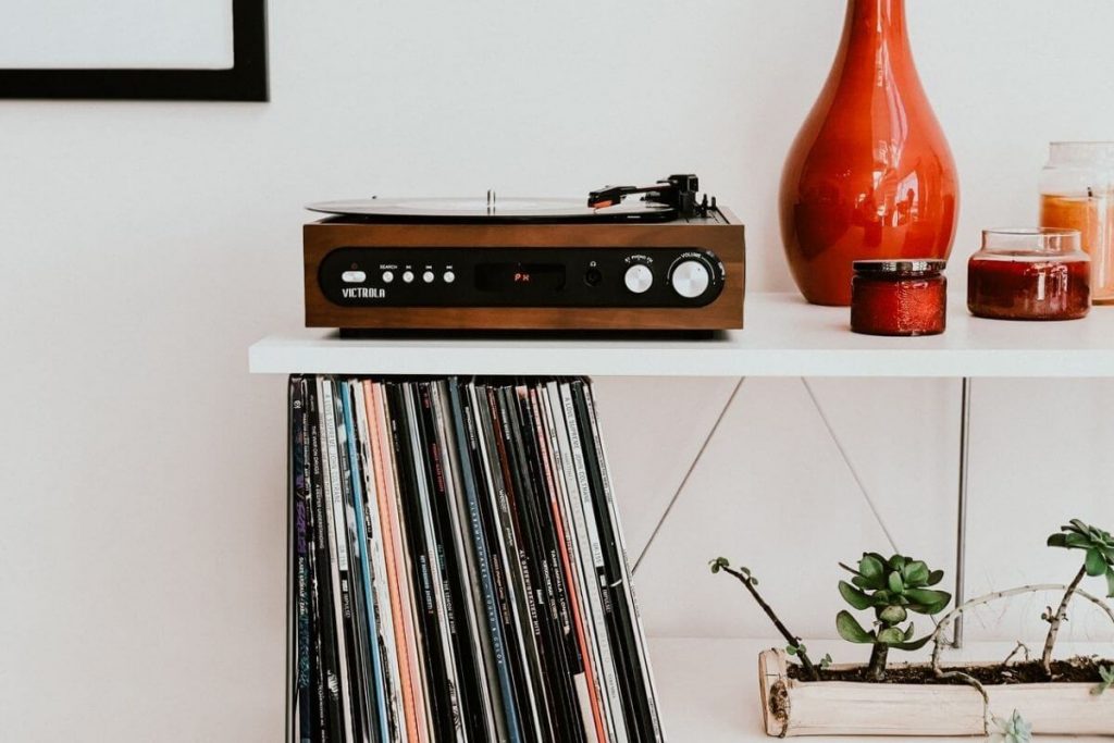 records and turntable with orange vase and candles