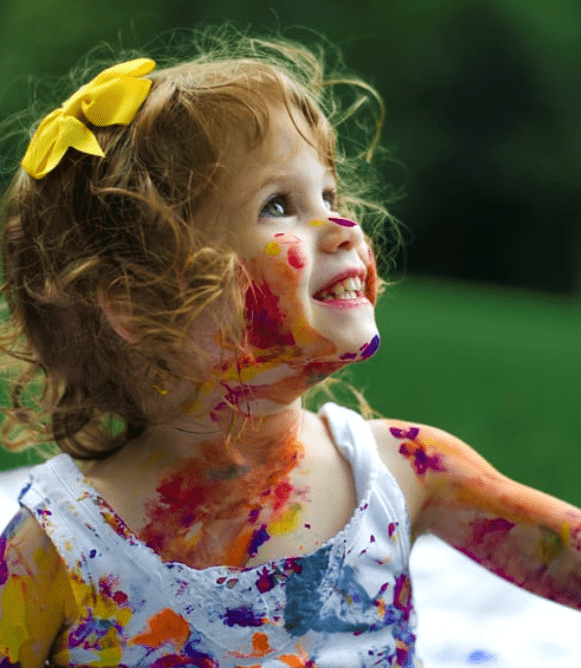 little girl with paint all over her parent needs life skills to cope