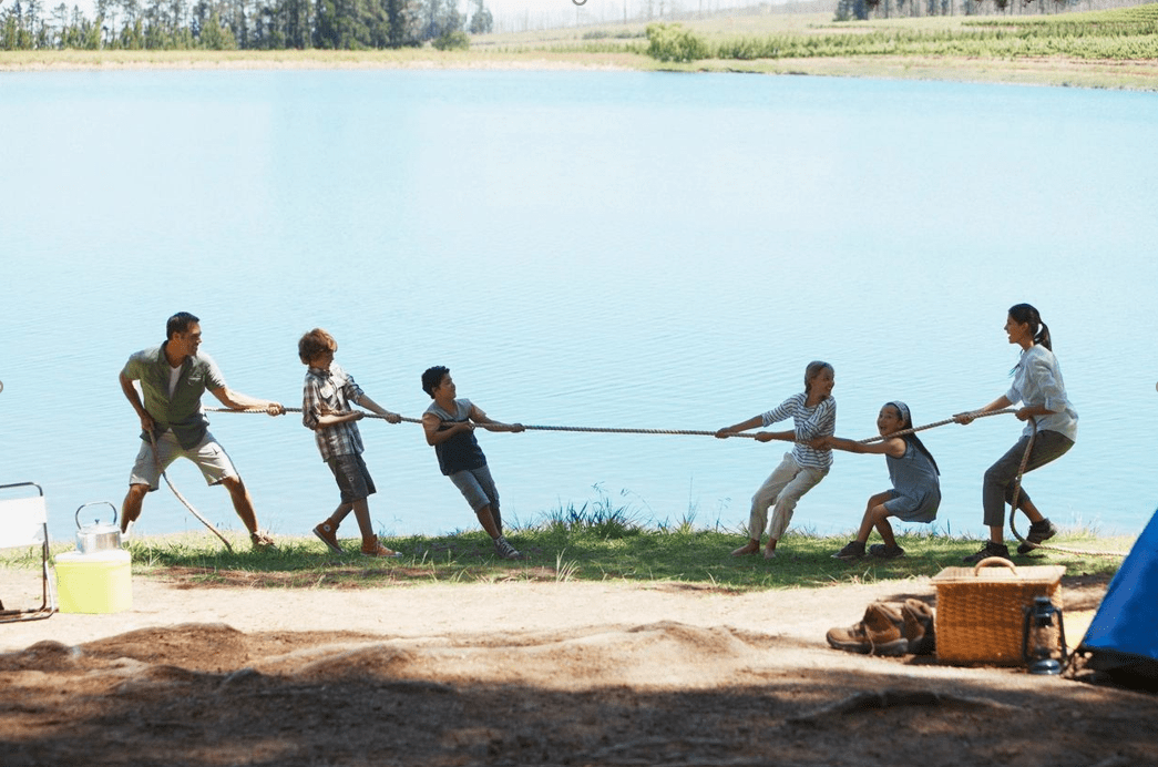 family enjoys game at lake learning about life skills