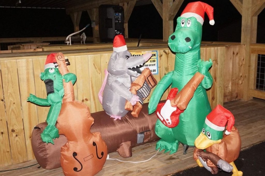 blow up holiday characters playing band instruments at jungle bells