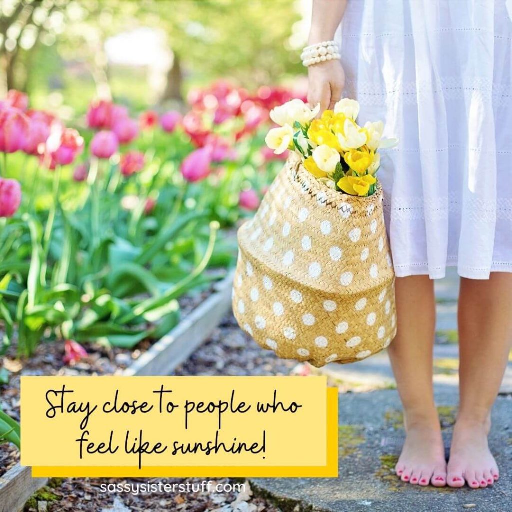 pink tulips a women in a white dress holding a yellow bag with yellow tulips in it and a quote about people who make you feel like sunshine