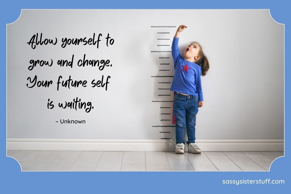 little girl measuring how tall she is against a wall with an excited look of joy on her face and a quote about personal growth