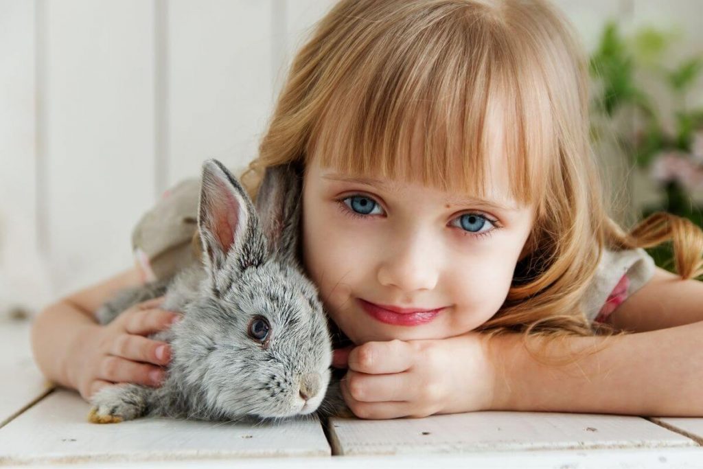 little girl hugging her pet bunny