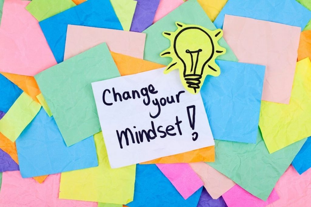 post it notes scatters about with a lightbult cutout and change your mindset note