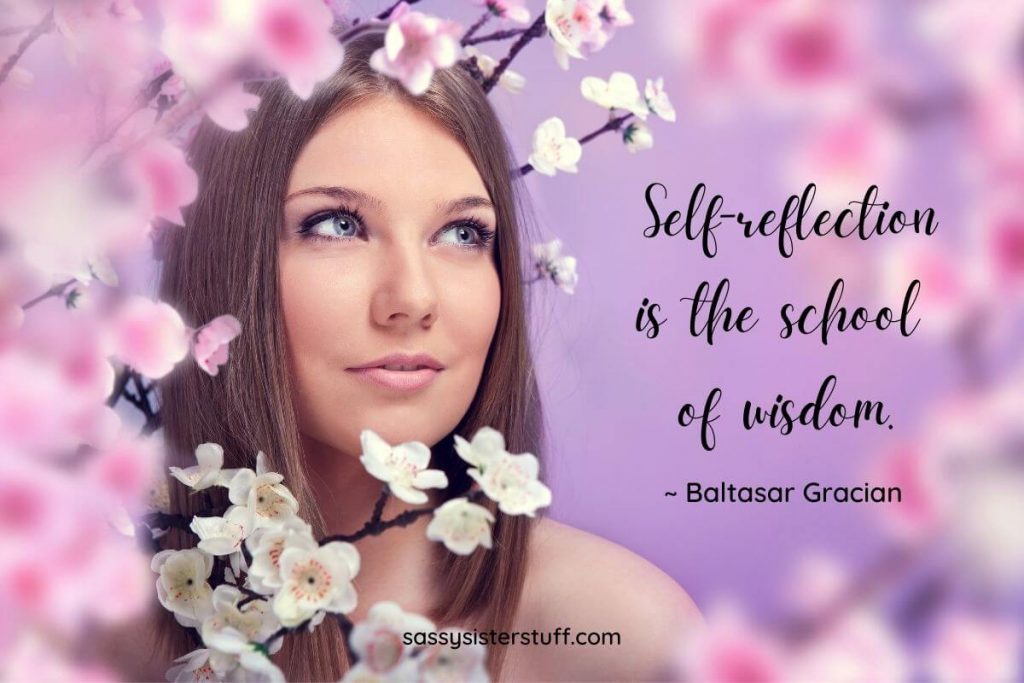 beautiful woman standing among cherry blossoms self reflecting with a self reflection quote