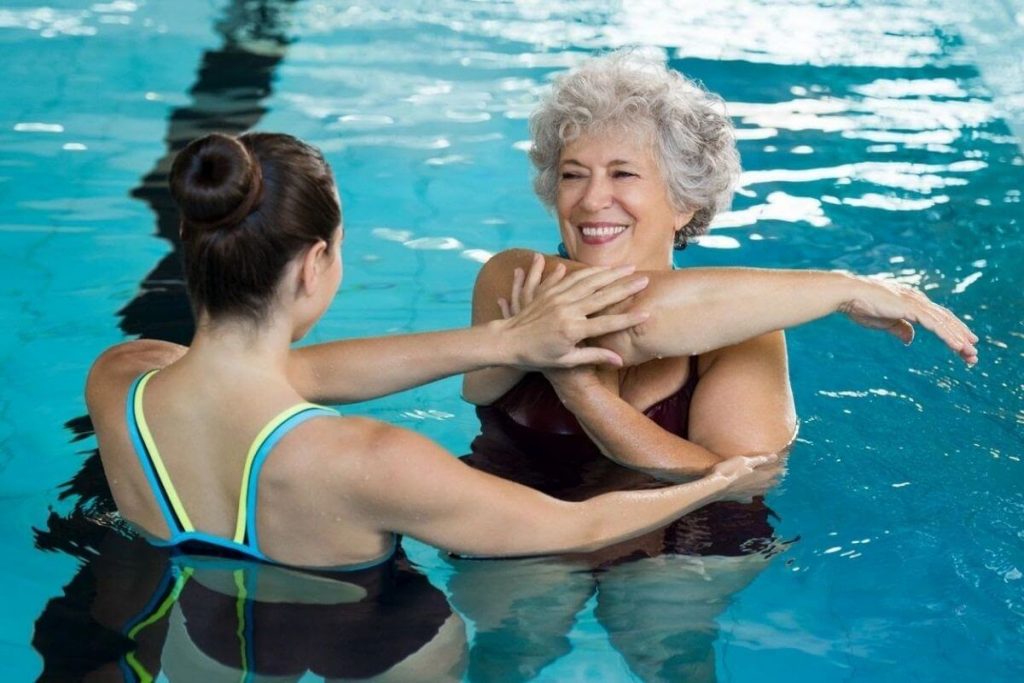 two women work out in the pool to stay healthy