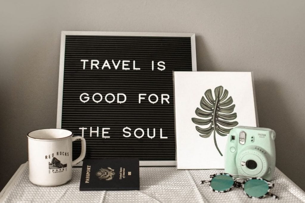 a display on a table that says travel is good for the soul answering the question why traveling is important