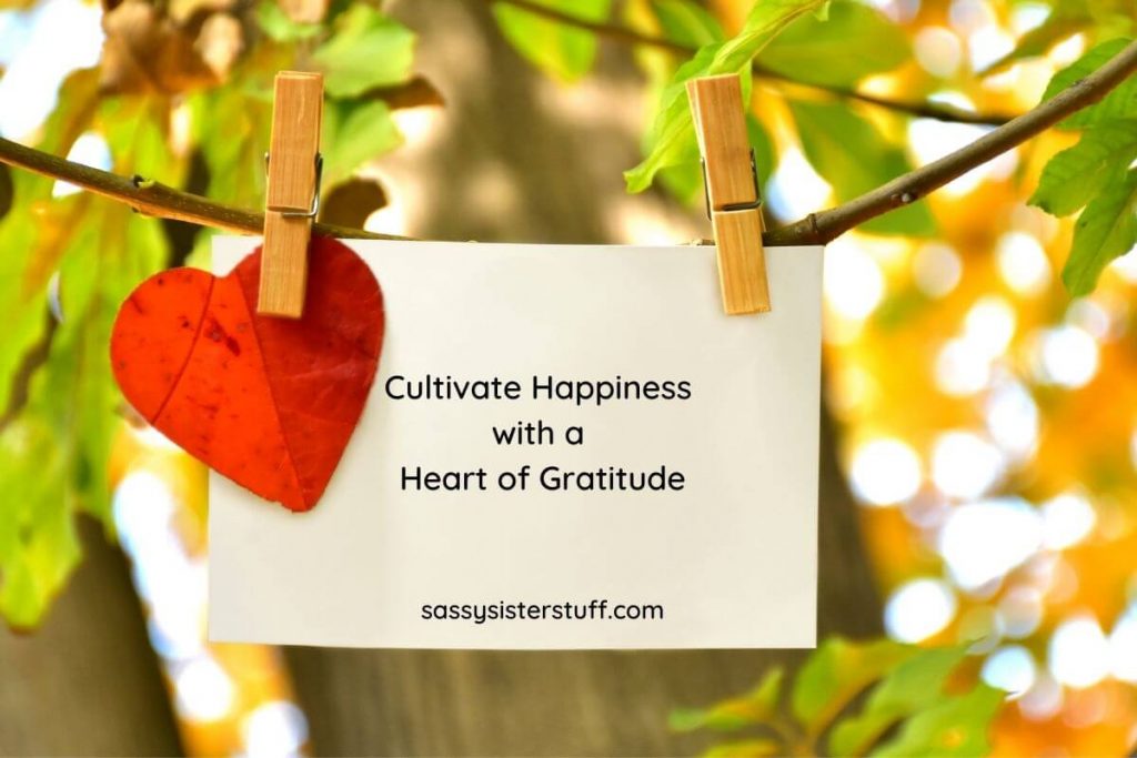 note hanging on a tree that says cultivate happiness with a heart of gratitude