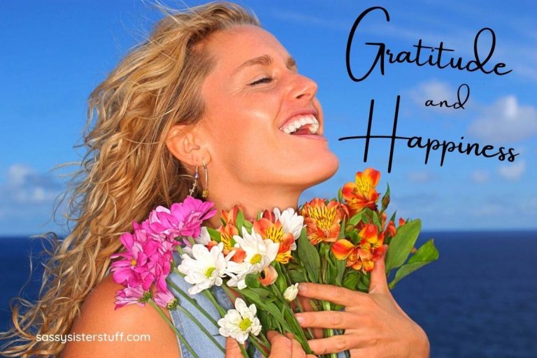 happy and grateful woman at the ocean holding a bouquet of flower