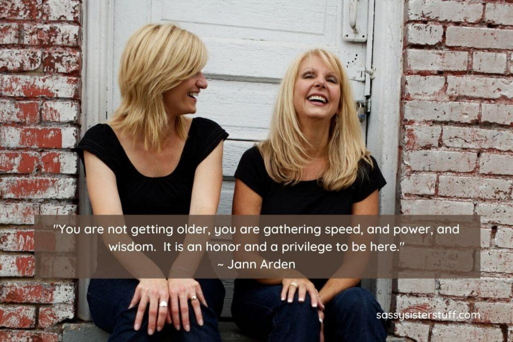 daily wellness tips for midlife with two happy middle aged women sitting on a stoop together