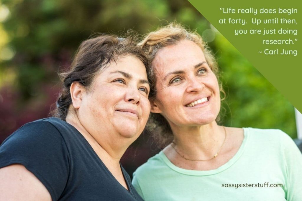 two happy middle aged women and a quote about midlife