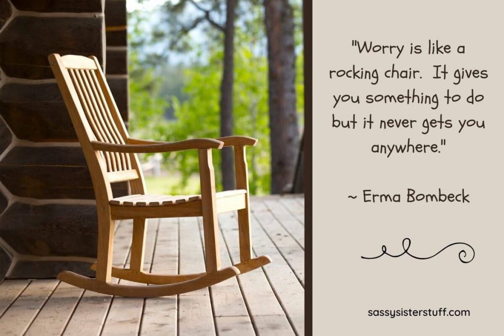 wooden rocking chair sitting on a log cabin porch with a quote about not worrying because it doesnt get you anywhere