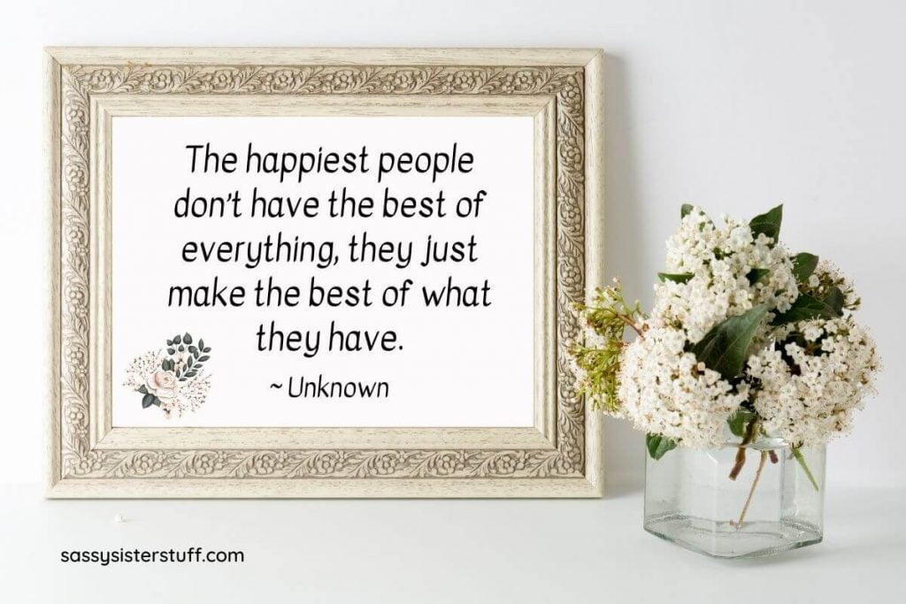 beautiful white flowers and a framed quote about how to be happy