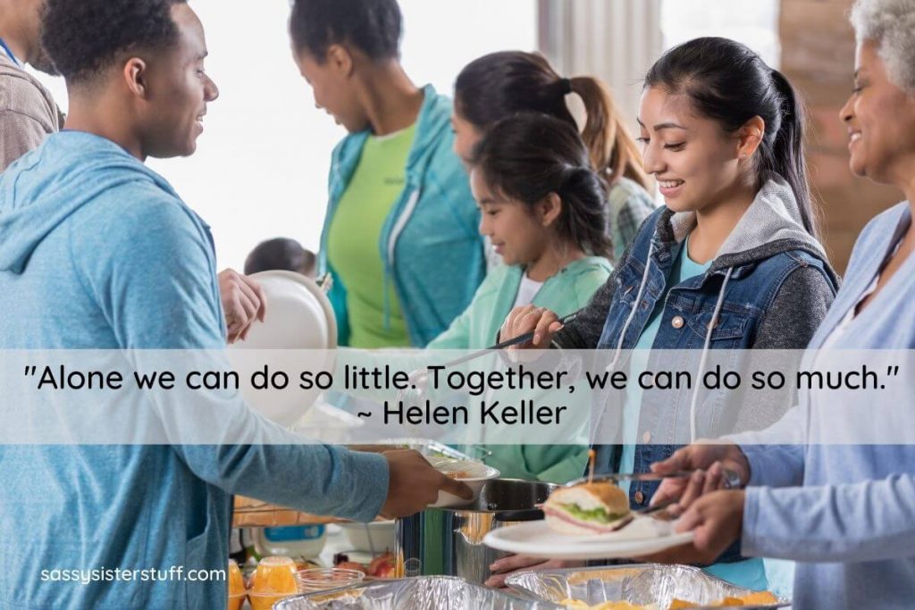 a diverse group of volunteers serve lunch at a shelter in their community