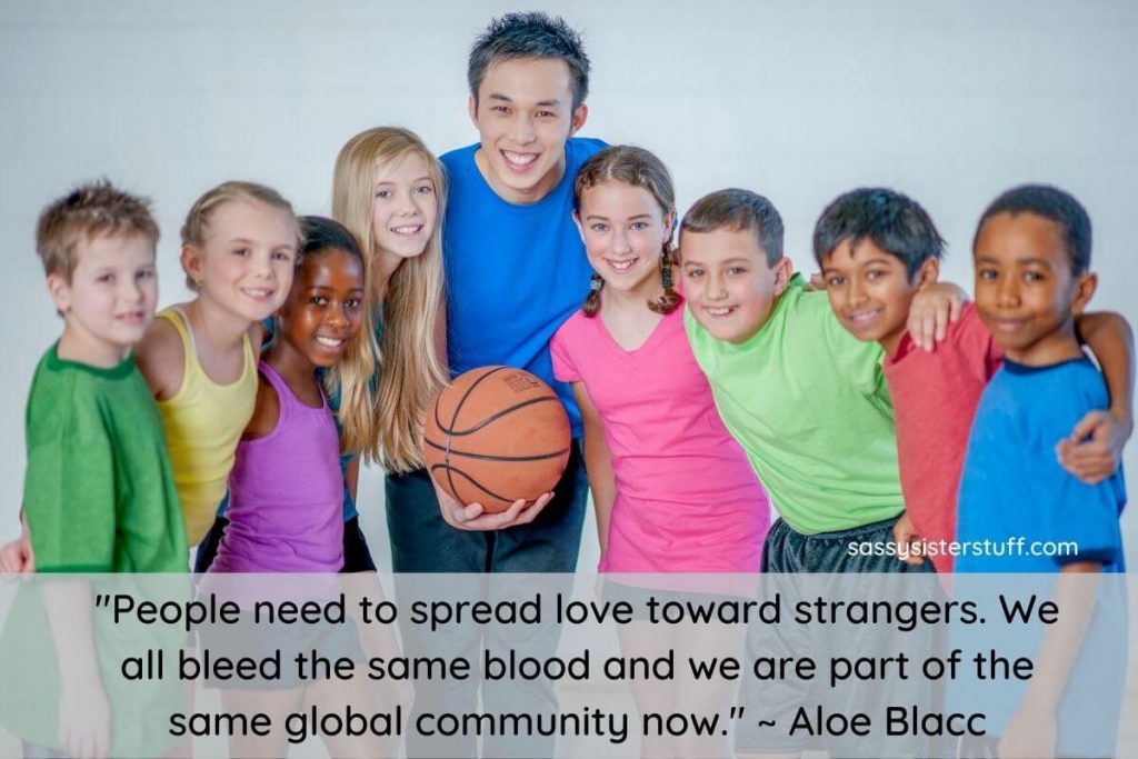 a young man volunteers to coach a youth basketball team in his community and pose for a photo