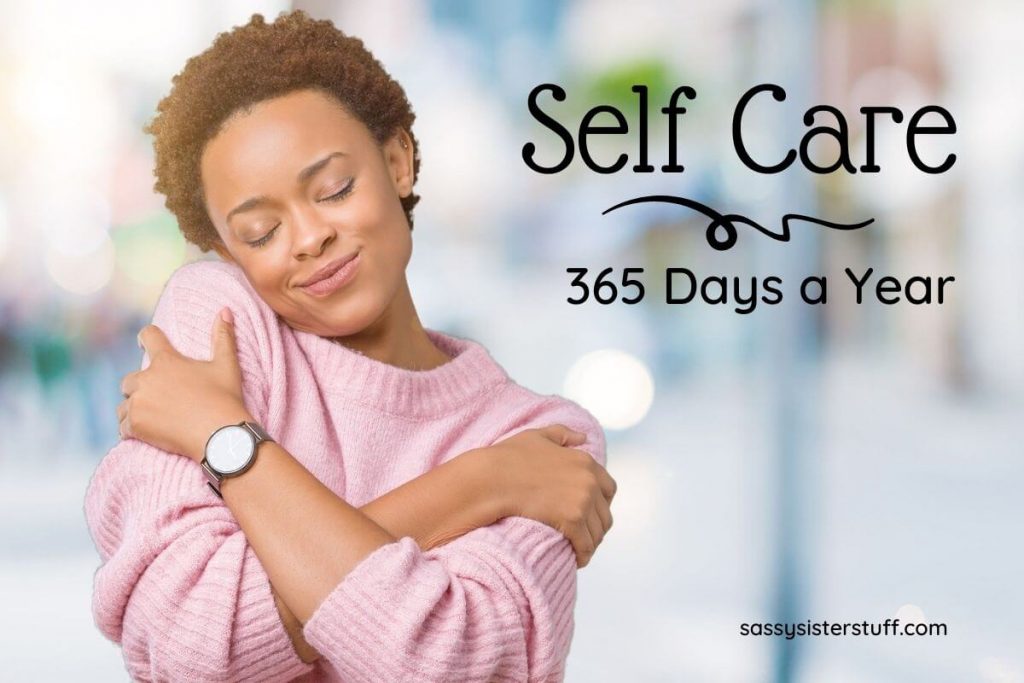 a young woman in a pink sweater hugs herself to show self care Sunday 365