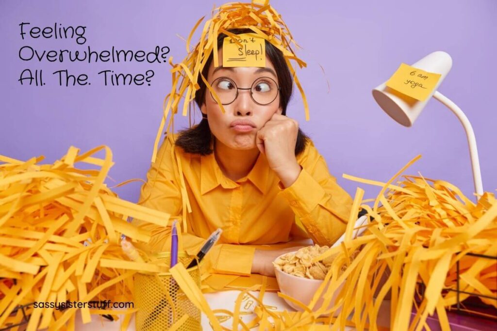 funny young woman sits crossed eyed with a bowl of corn flakes in front of her and a post it note on her forehead that says dont sleep and shredded yellow paper all over the place on her desk and her head as if overwhelmed and addicted to stress