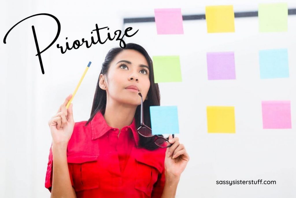 a young business woman looks at colored sticky notes on a board and thinks about how to prioritize tasks to represent business skills that can help improve your personal life