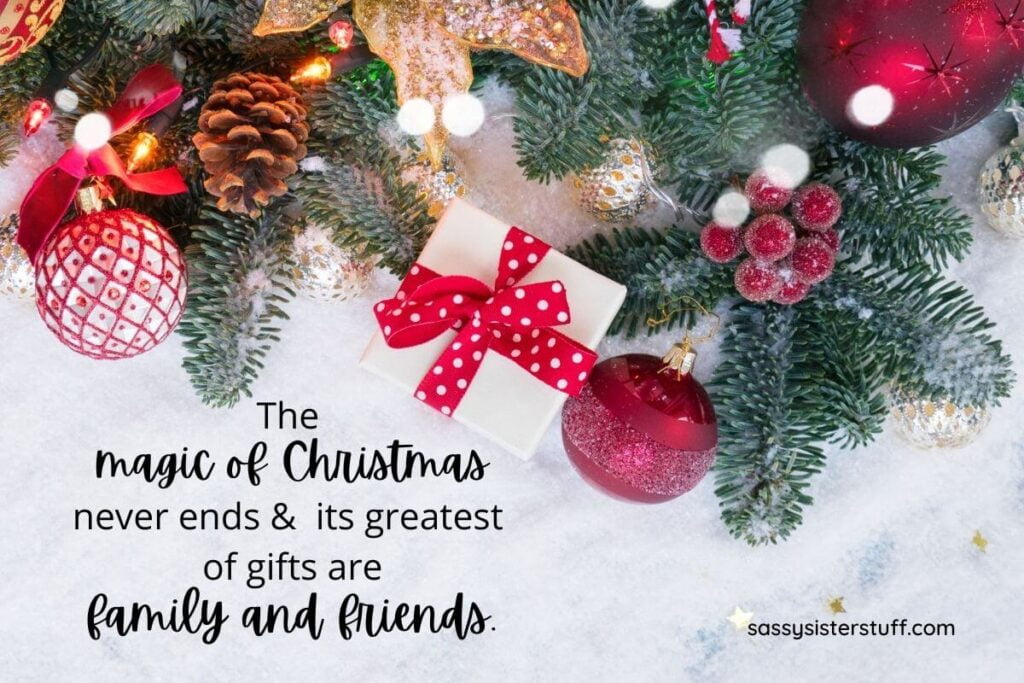 red ornaments and greenery and pine cones laying on a white snowy background with a quote about how to get in the christmas spirit