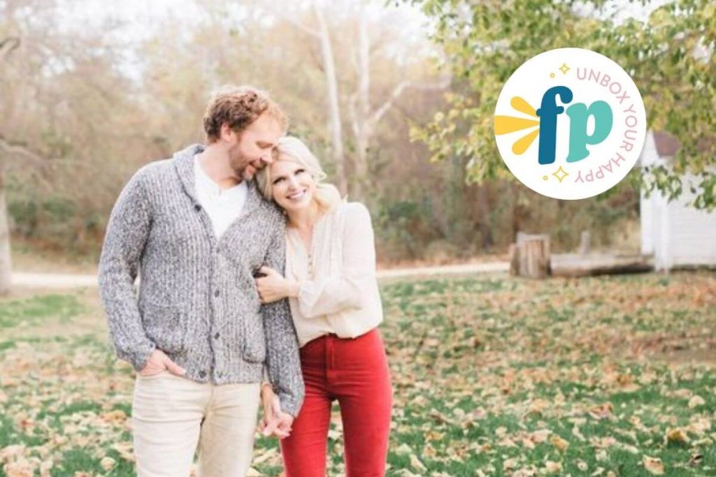 Freckled Poppy Owners Alex and Matty standing together in an autumn yard with leaves on the ground