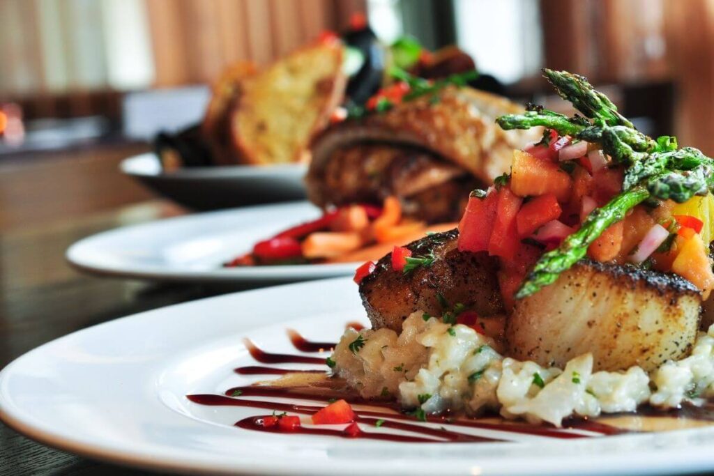 three plates of beautiful presented dinners with meat and vegatables