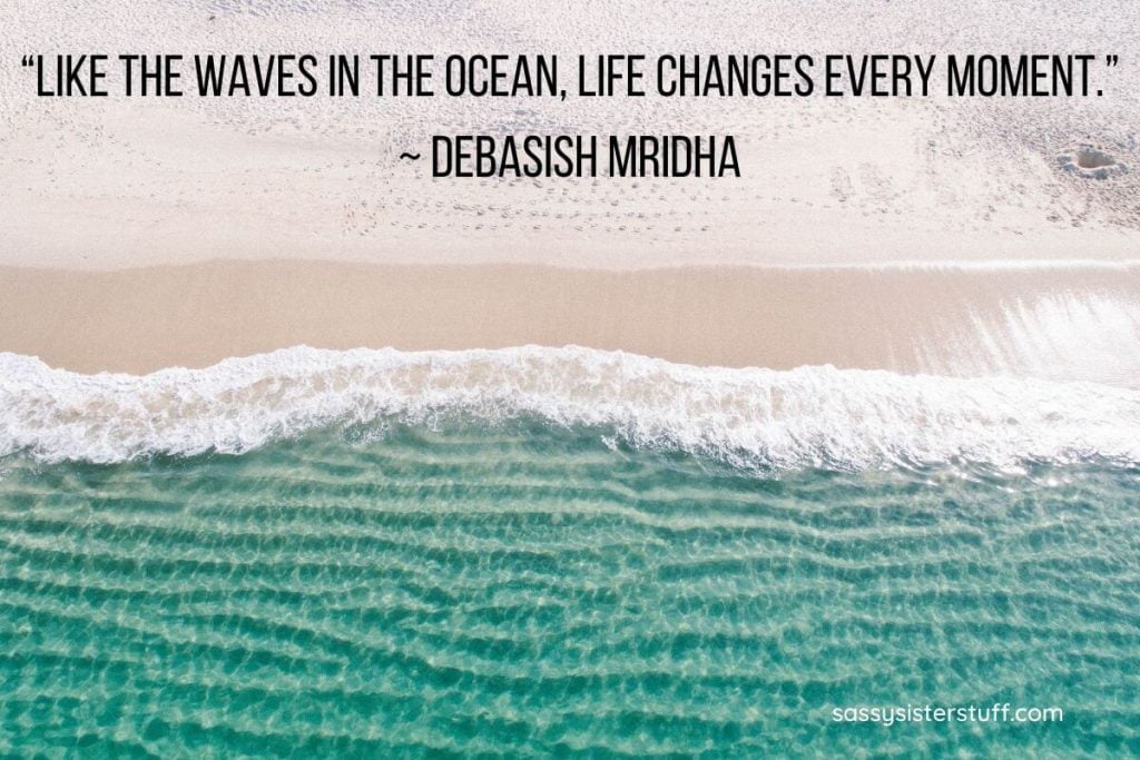 ocean waves crashing against a sandy beach and a quote about transitions in life