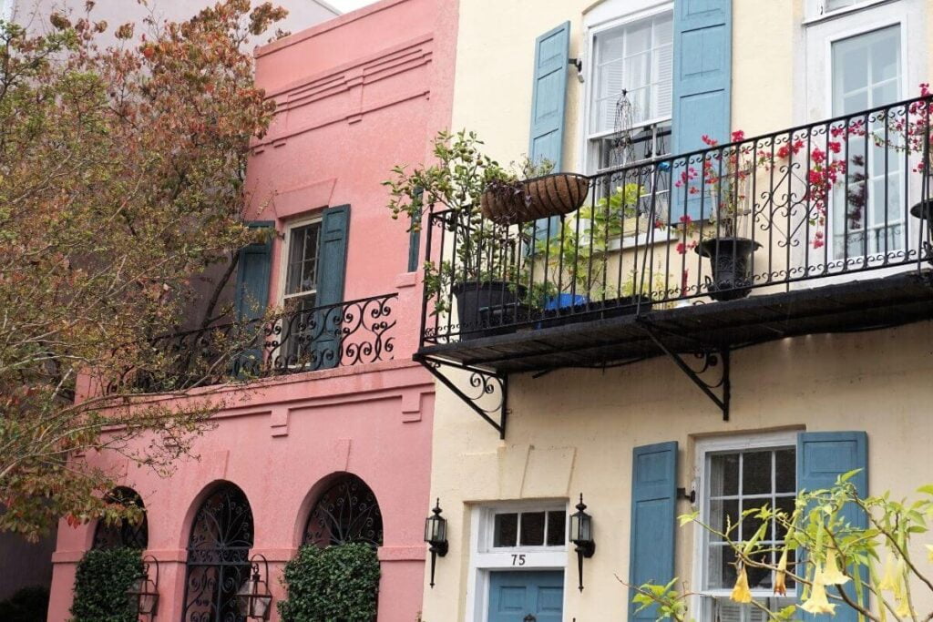 a pink and yellow house on rainbow row houses in charleston sc