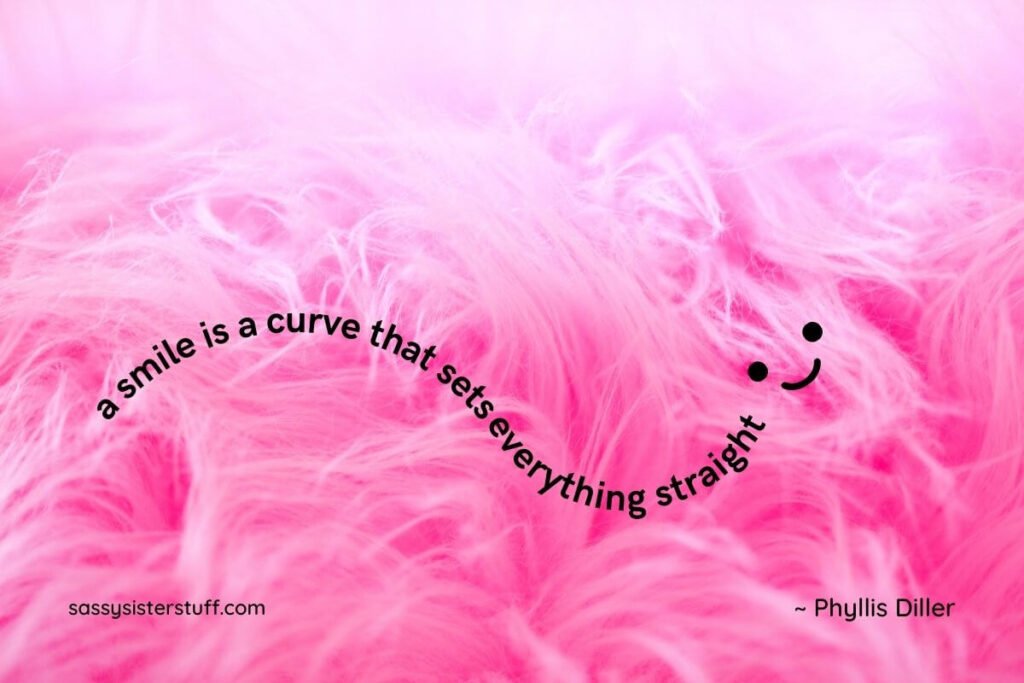 pink fuzzy blanket with a smile quote that by phyllis diller and a small happy face