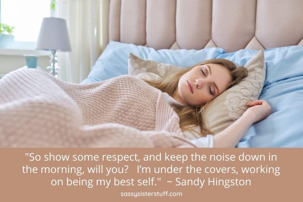 a young woman sleeps peacefully in her luxurious bed under covers with a quote about showing respect to night owls