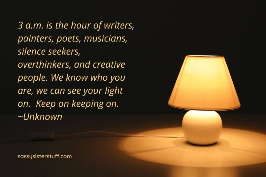 a black background with a pale yellow lamp sitting on a table lighting the room and a quote about night owls