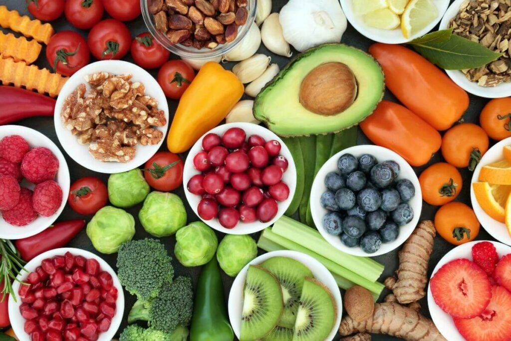 a top view of fresh fruits and vegetables and nuts for a healthy diet