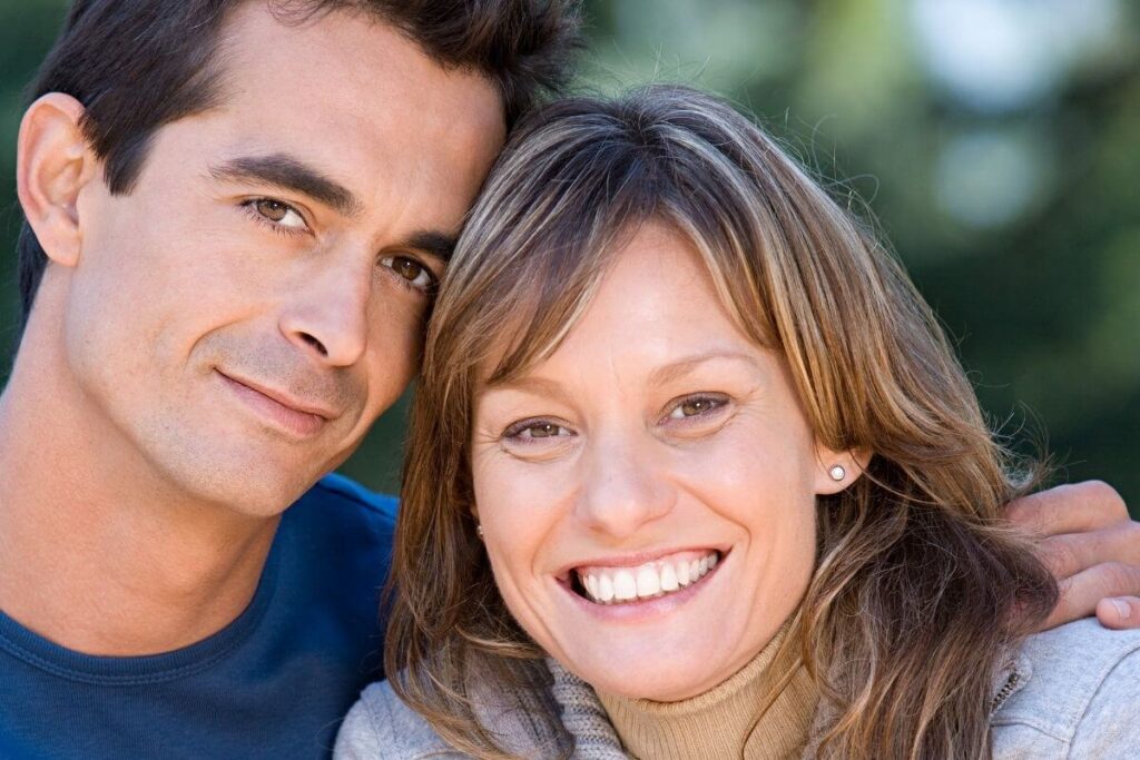 a close-up of a happy couple looking at the camera after a discussion about top marriage problems and solutions because they want to work on improving their marriage