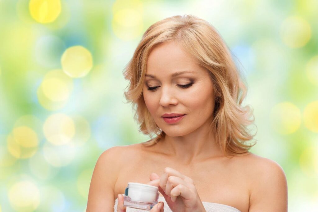 a young blonde woman holds a new face cleanser because she has fallen in love with taking care of herself