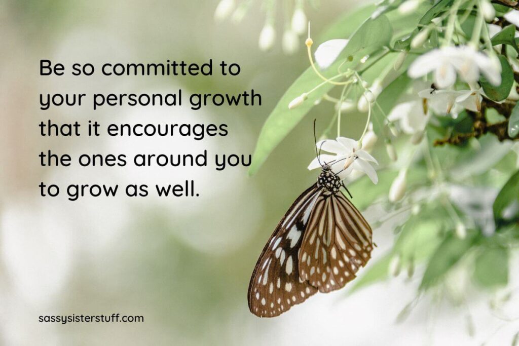 a beautiful photo in shades of green with white flowers and a brown butterfly on one side and a personal growth quote on the other side of the image