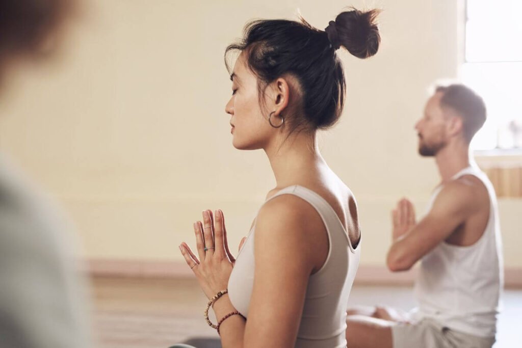 a young Asian woman does mindfulness yoga and meditation