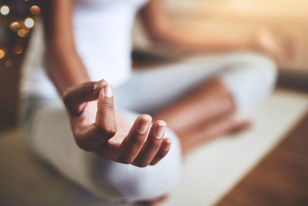 a close up of a female in the yoga position focused on mindfulness affirmations