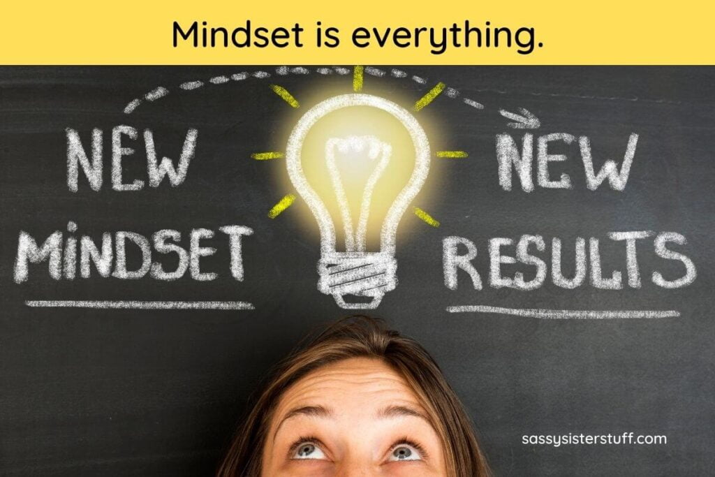 a woman stands below a chalkboard with her eyes rolled up to see a lightbulb drawn above her head and new mindset new results written on on the sides of the lightbulb