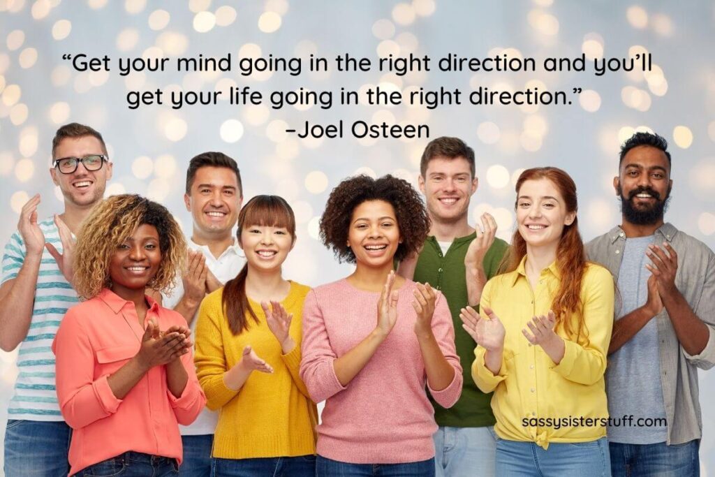 8 people stand side by side clapping to show that they are going in the right direction with a positive mindset