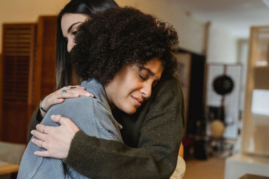 two women embrace and comfort each other because they always choose kindness