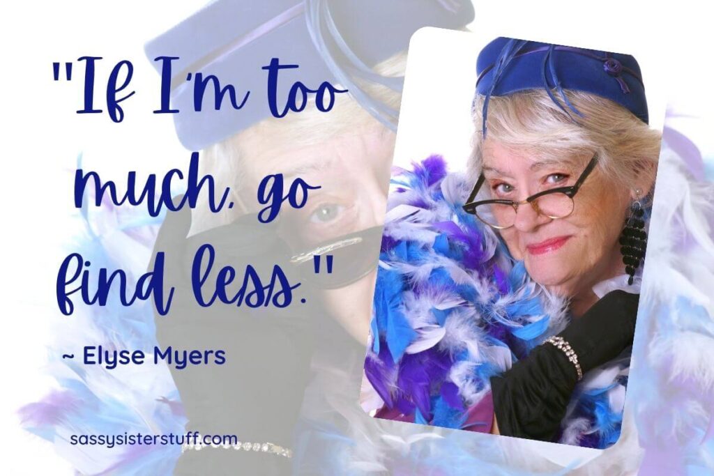 a senior woman wears a purplse and blue feather boa and hat and peers over her sassy glasses glancing at the camera confidently