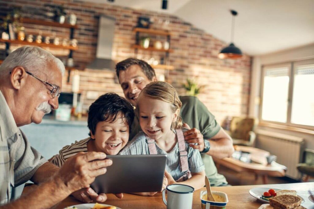 three generations of family members play games together on an iPad