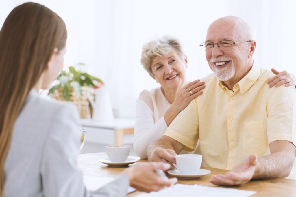 a young women enjoys a visit with her aging parents who moved into an assisted living facility