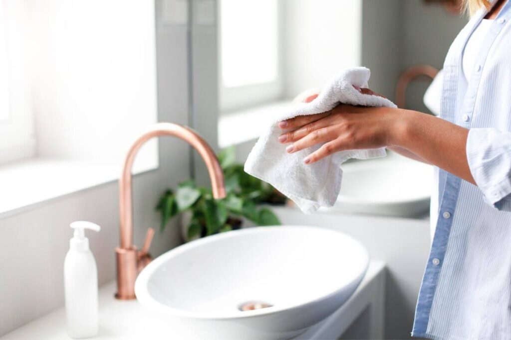 a close up of a woman washing her hands to ensure she is staying healthy